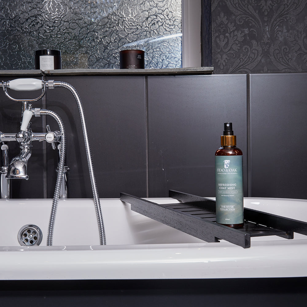 Bottle of Fido & Oak Coat Mist on a black tray next to a bathtub.
