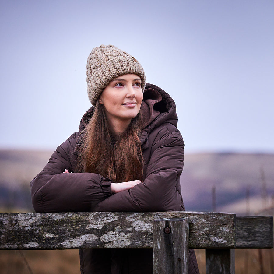 Woman standing outdoors looking to the left