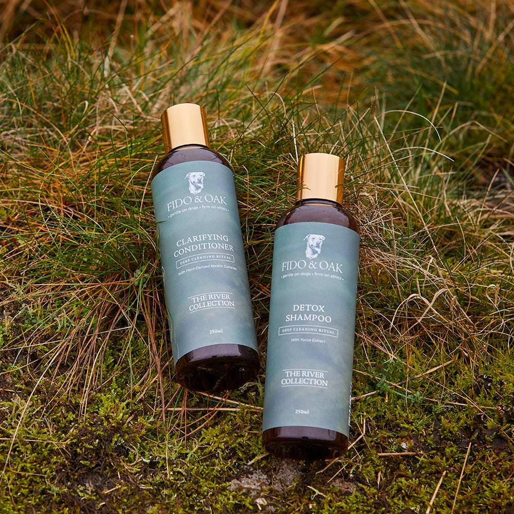 Fido & Oak detox shampoo and clarifying conditioner bottles on grass